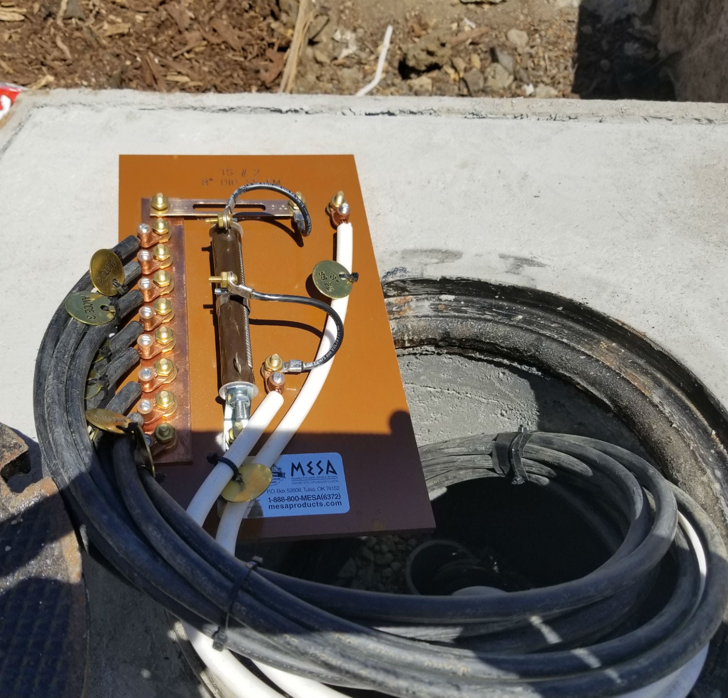 A bunch of wires are connected to the top of a pipe.